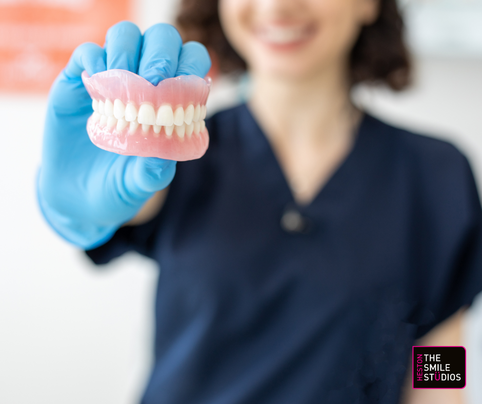 Close up of dentures handheld by a dentist